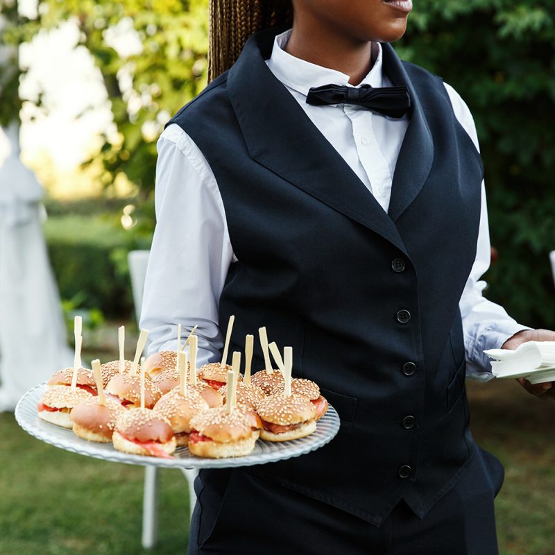 Waiter carries plate with tasty snacks Waiter carries plate with tasty snacks